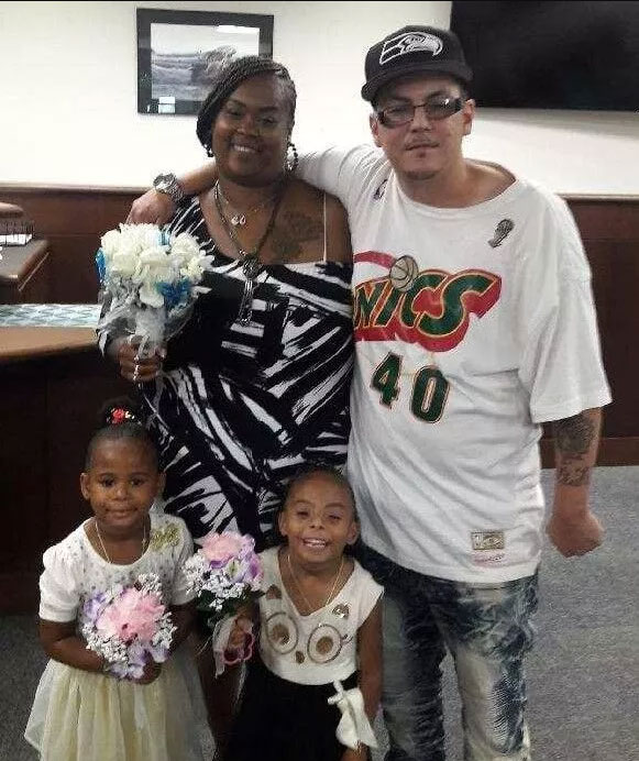 Kandyce Benefield stands next to her husband, daughter and step-daughter on her wedding day